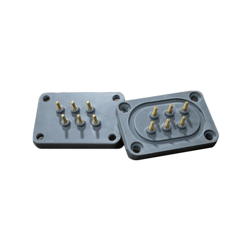 Two rectangular gray plastic connector plates, each with six gold metal pins arranged in two rows. One plate is shown face-up and the other face-down, both have four mounting holes at the corners.