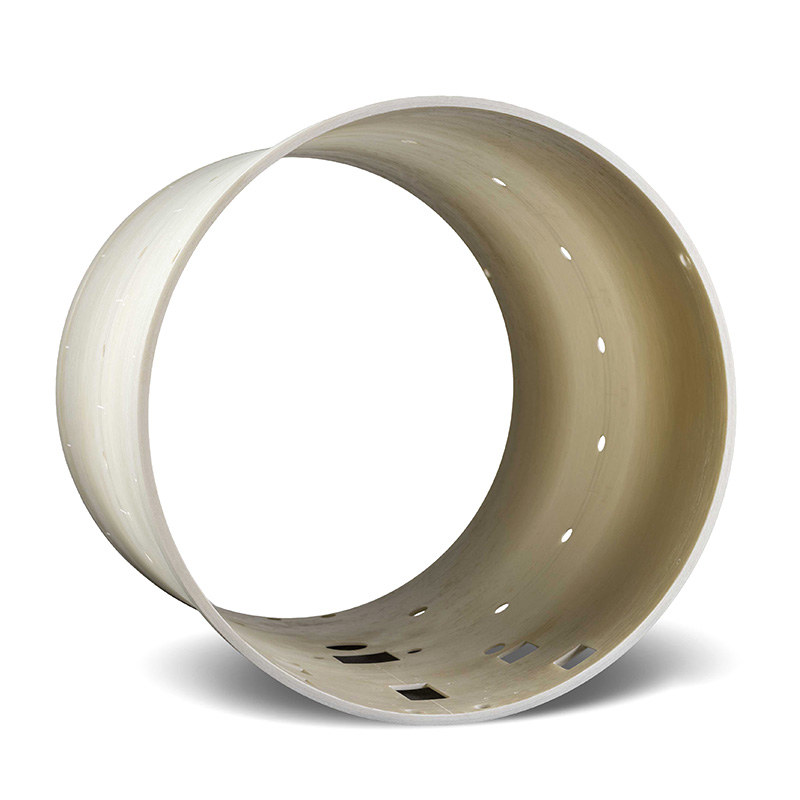 A large, hollow, cylindrical metal ring with a smooth, light-colored surface and multiple small holes and square cutouts along its side, standing upright against a white background.